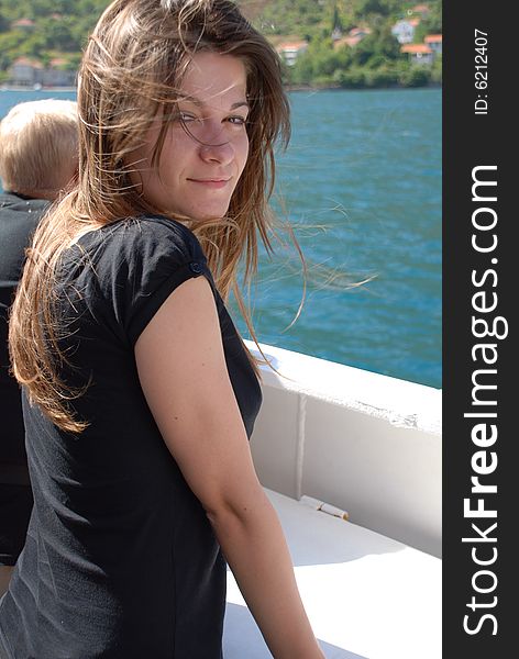 Portrait of young adult woman leaning against fence