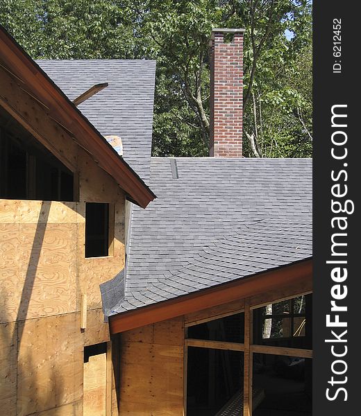 Construction showing completed roof, and chimney, with sheathed but un-sided walls, and frames for windows. Construction showing completed roof, and chimney, with sheathed but un-sided walls, and frames for windows.