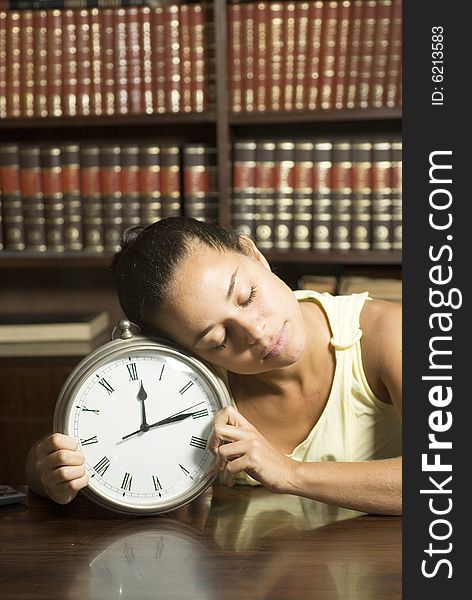 Female student sleeping in an office on a clock. Vertically framed photo. Female student sleeping in an office on a clock. Vertically framed photo.