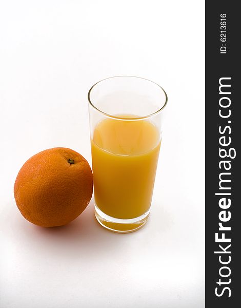 Orange and refreshing glass of orange juice. Orange and refreshing glass of orange juice