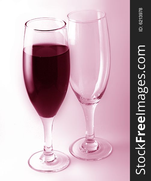 A glass of red wine with a empty glass