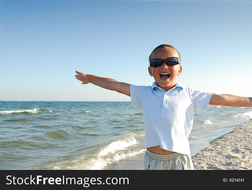 Happy little boy playing on the beach. Happy little boy playing on the beach