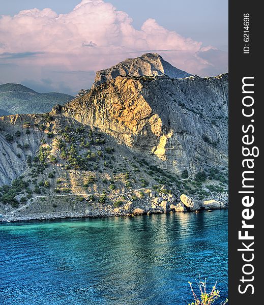 Hdr image of evening sea landscape with red clouds and bay