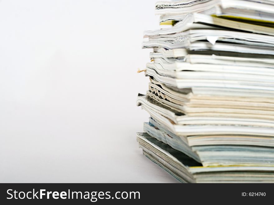 Stack of magazines on neutral background closeup