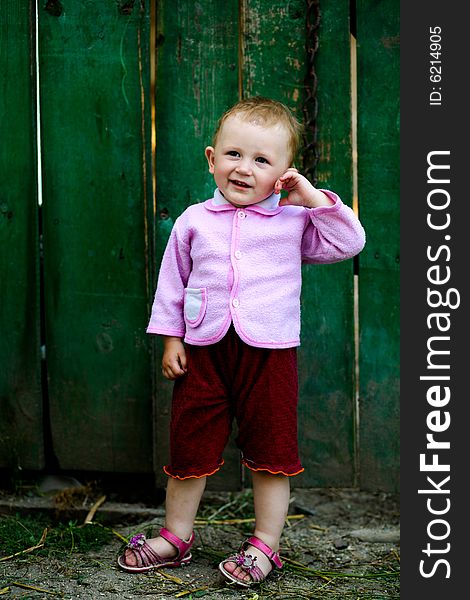 Portrait of a girl on a background of fence. Portrait of a girl on a background of fence