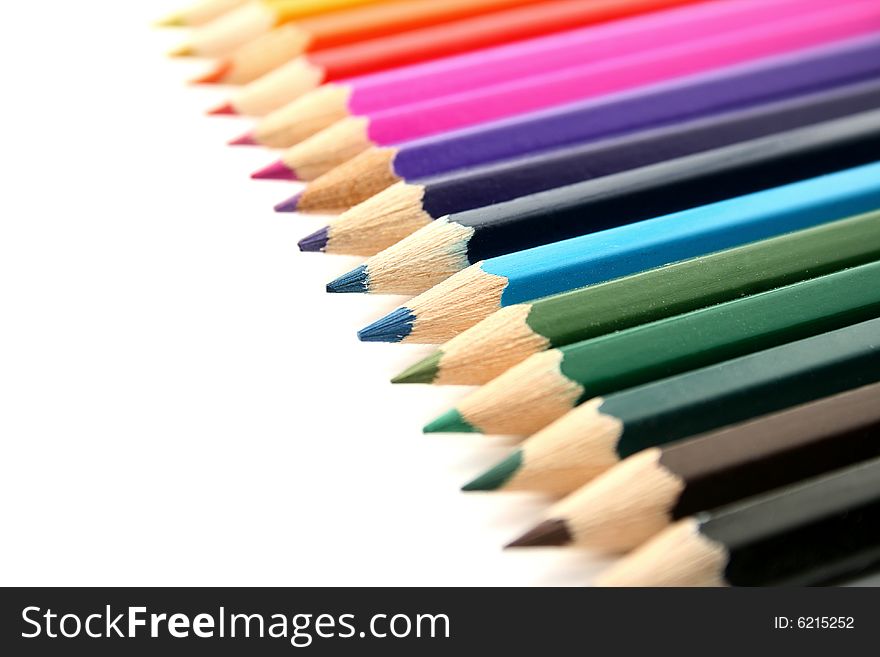 Line of crayons on white background