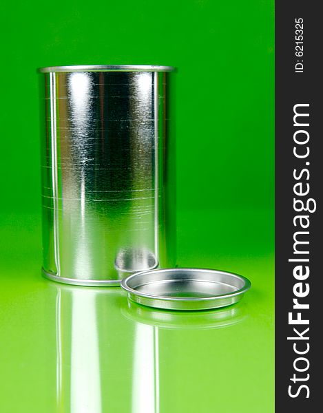Assorted tins isolated against a green background. Assorted tins isolated against a green background