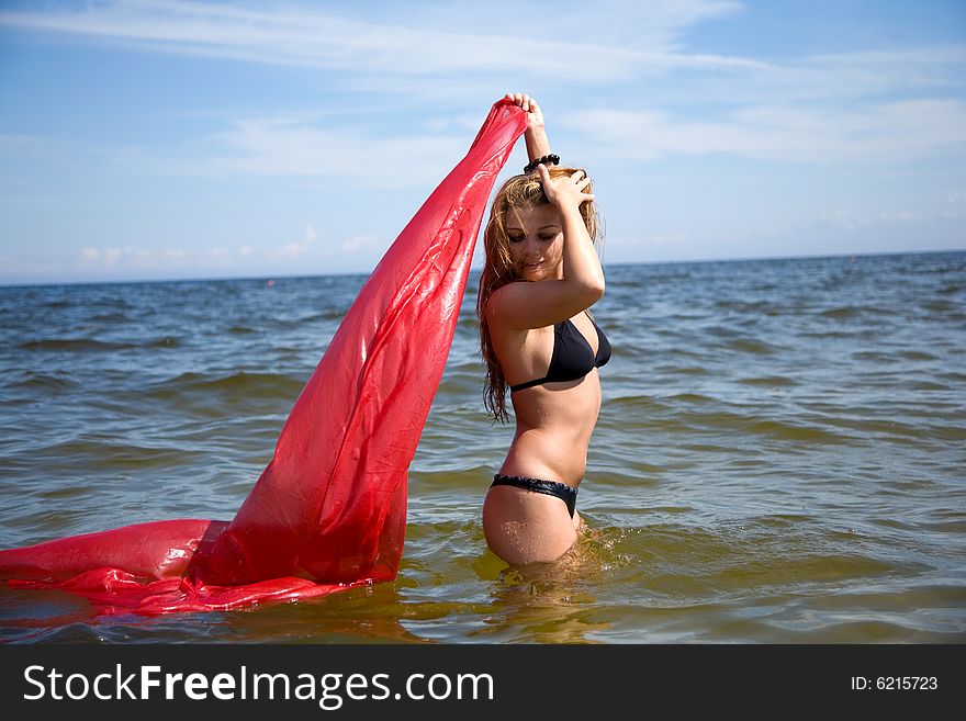 Beautiful Girl Swimming With Red Shawl