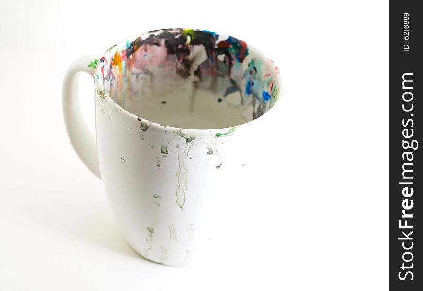 A white mug with paint on it. A white mug with paint on it.