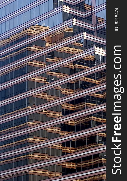 A modern glass brown reflective building with many angles. A modern glass brown reflective building with many angles