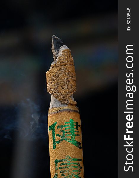 Buddhist aroma stick with smoke on black background