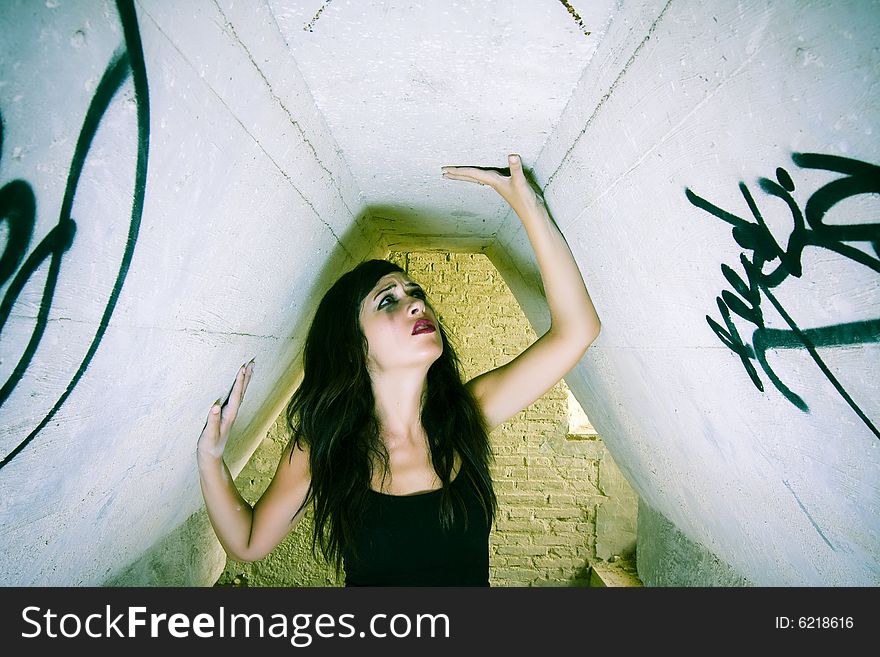 Terrified young woman inside of dirty place. Terrified young woman inside of dirty place.