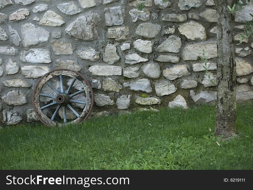 A wall with an ancient wheel. A wall with an ancient wheel
