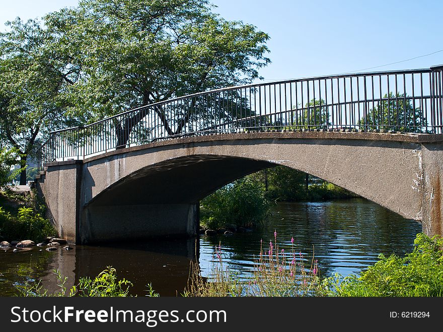 Scenic walking bridge arches over the charles river in boston massachusetts on a clear summer day