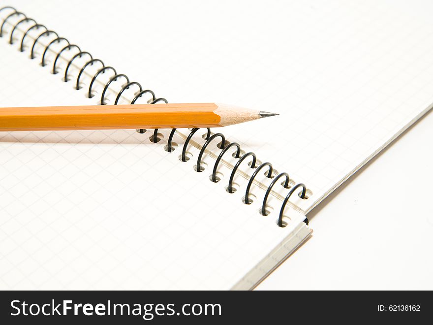 Opened notebook with a blank sheet and pencil on over white. Opened notebook with a blank sheet and pencil on over white