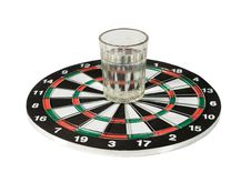 Glass Of Water On A Dartboard Royalty Free Stock Photos