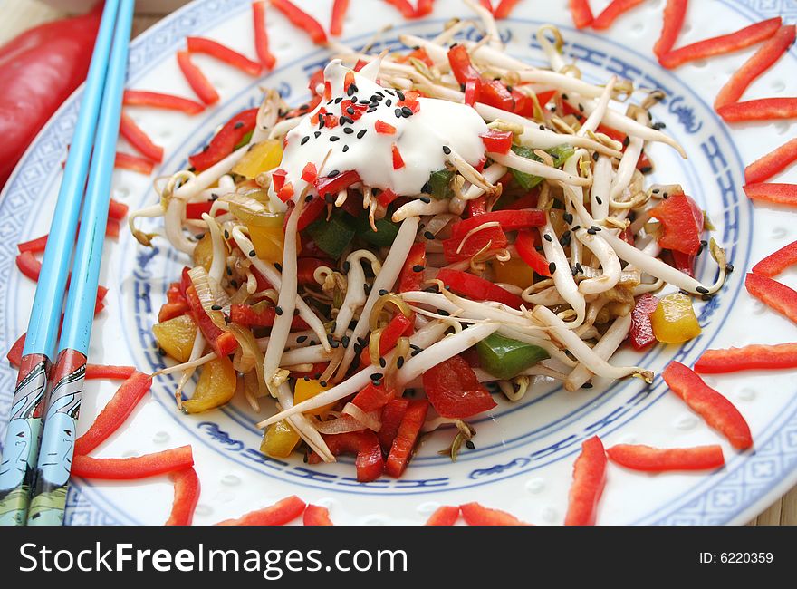 An asian salad of fresh vegetables on decorativ table-ware