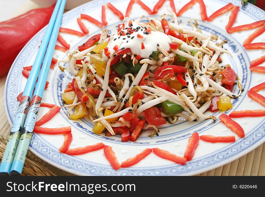 An asian salad of fresh vegetables on decorativ table-ware
