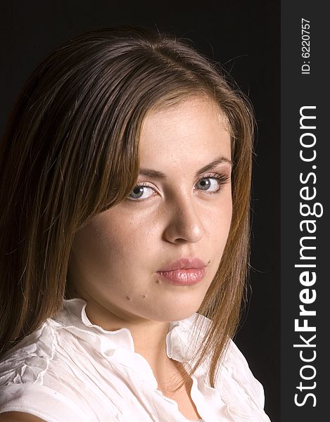 Closeup of pretty hispanic model looking over shoulder isolated on black