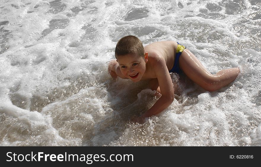 Happy child playing on the beach