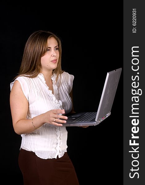 Closeup of pretty hispanic model with laptop over a black background