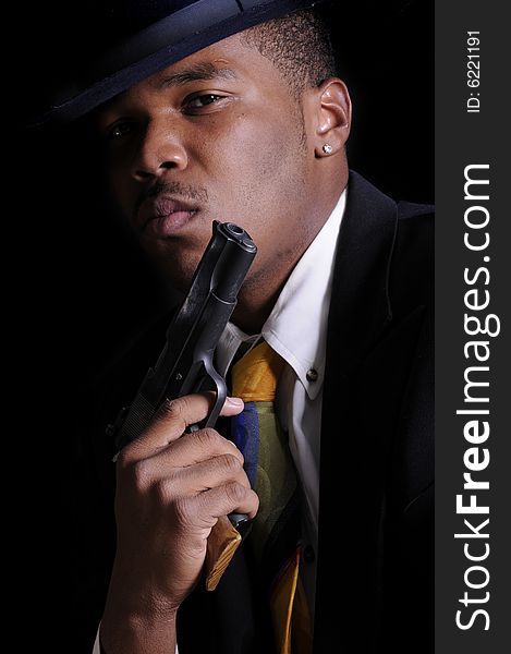 Male model, Kabari Jackson dressed a gangster in a shirt, tie, jaclet and fedora. Male model, Kabari Jackson dressed a gangster in a shirt, tie, jaclet and fedora.