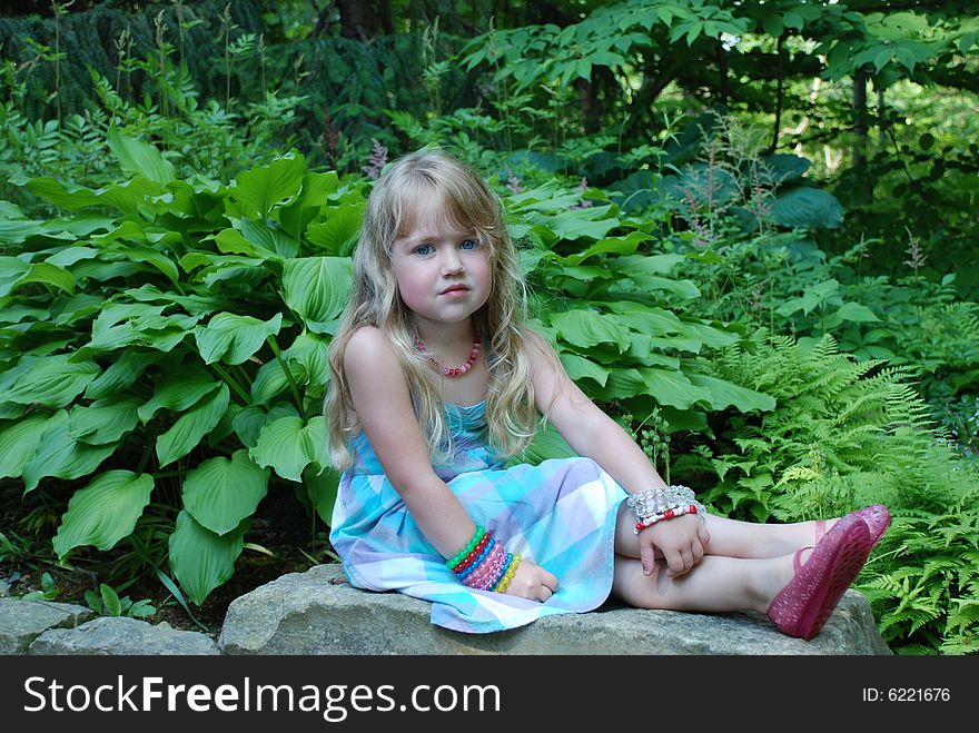 A portrait of a young girl in a garden. A portrait of a young girl in a garden.