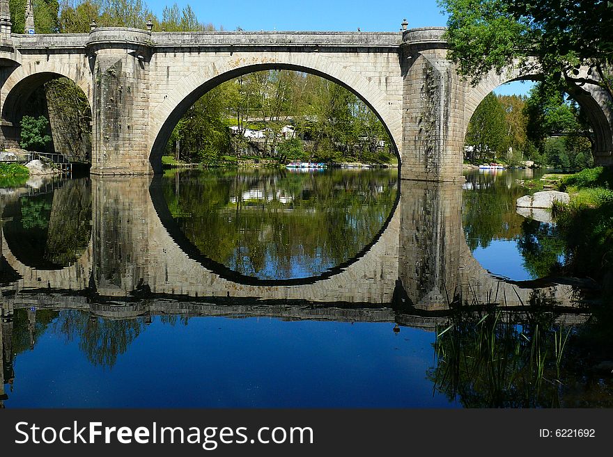Reflection of and Historical Bridge located in southwestern Europe, Portugal. Reflection of and Historical Bridge located in southwestern Europe, Portugal