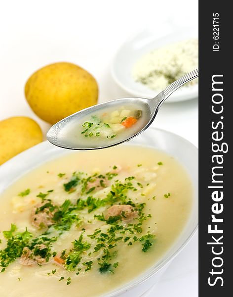 Potato cream soup with chopped meat balls.