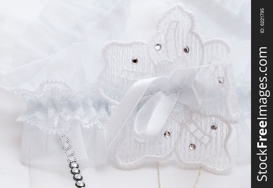 Wedding details. garter with flower and jewelry