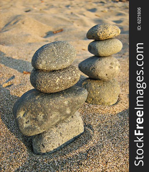 Two towers of stones on the beach. Two towers of stones on the beach