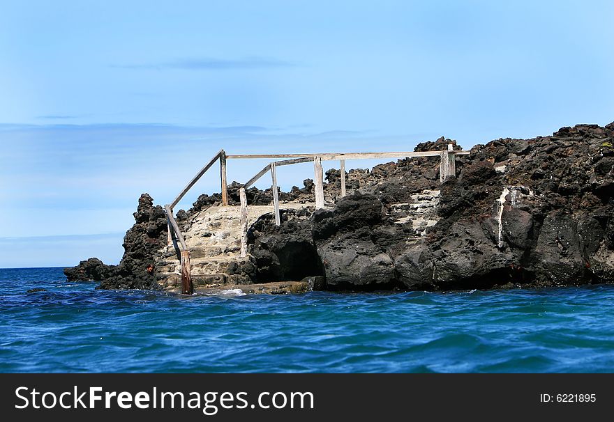 Old steps lead down into the ocean on the Galapagos Islands. Old steps lead down into the ocean on the Galapagos Islands