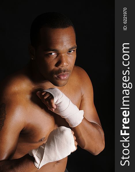 African american boxer with hands in bandages, warming up