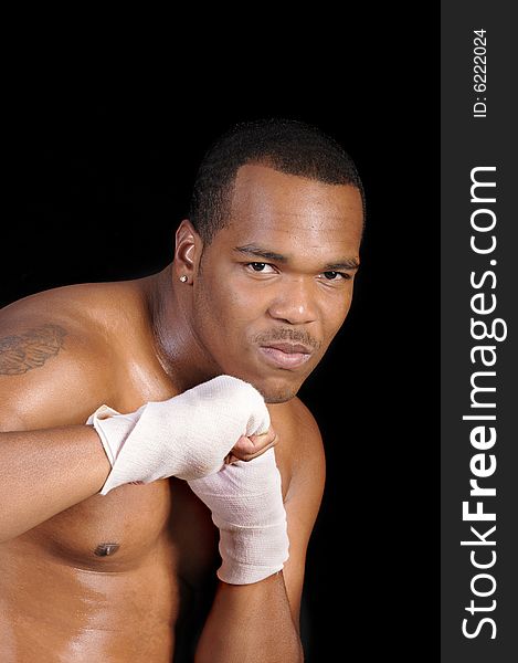 African american boxer warming up over a black background