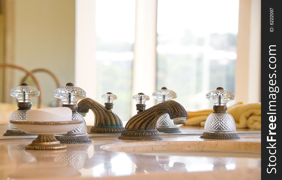 Granite counter sink with old fashioned faucet and handles in a La Jolla mansion. Granite counter sink with old fashioned faucet and handles in a La Jolla mansion.