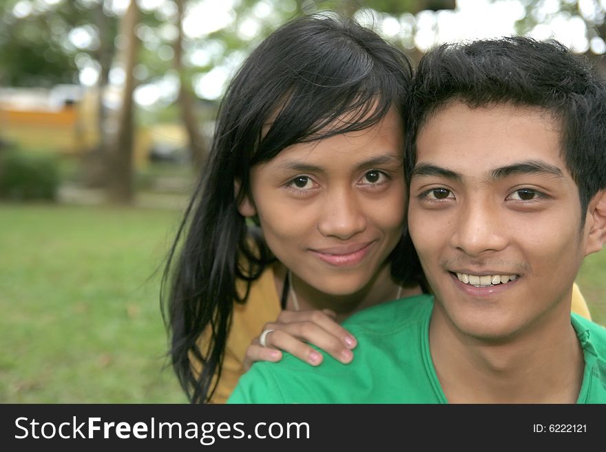 Young happy asian couple at park