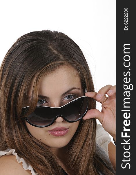 Closeup of pretty hispanic model looking over sunglassesisolated on white