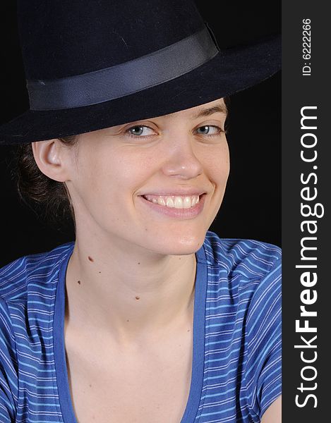 Beautiful russian woman in closeup with hat on isolated on black