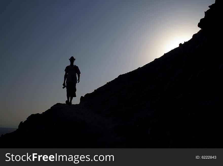 Silhouette of the man in the mountain sunset