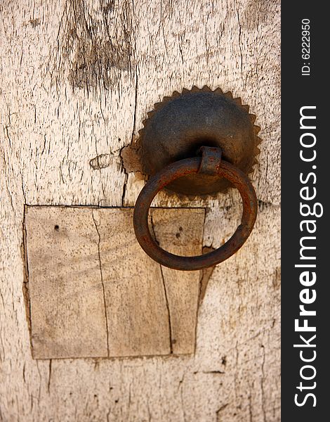 Old rusty metal handle on wooden door