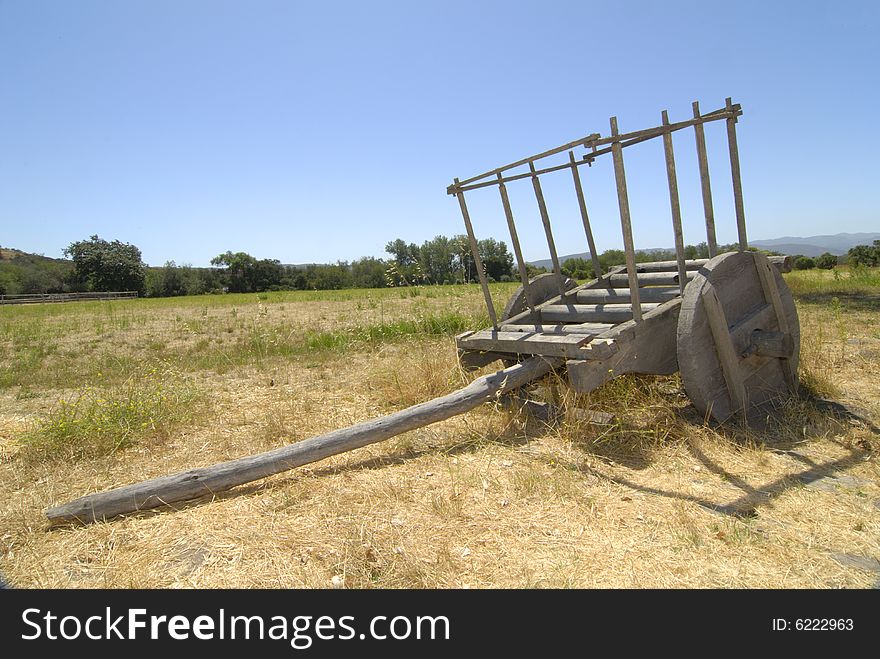 Old wooden ox cart in field