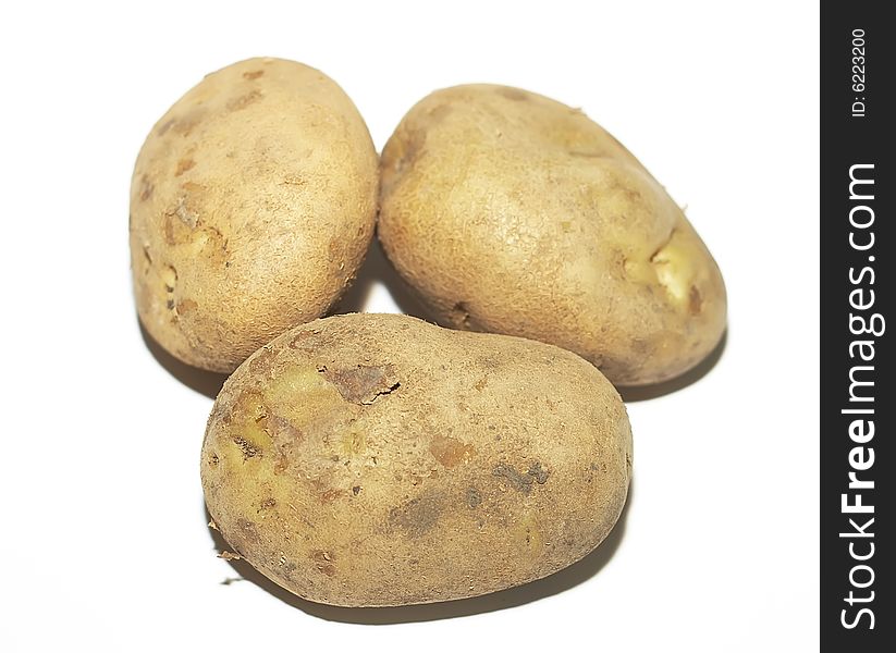 Three crude potatoes on a white background. Three crude potatoes on a white background