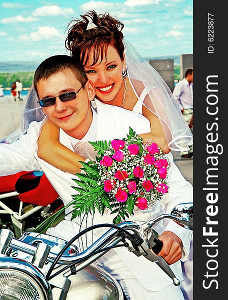 Bridegroom and bride on the motorcycle