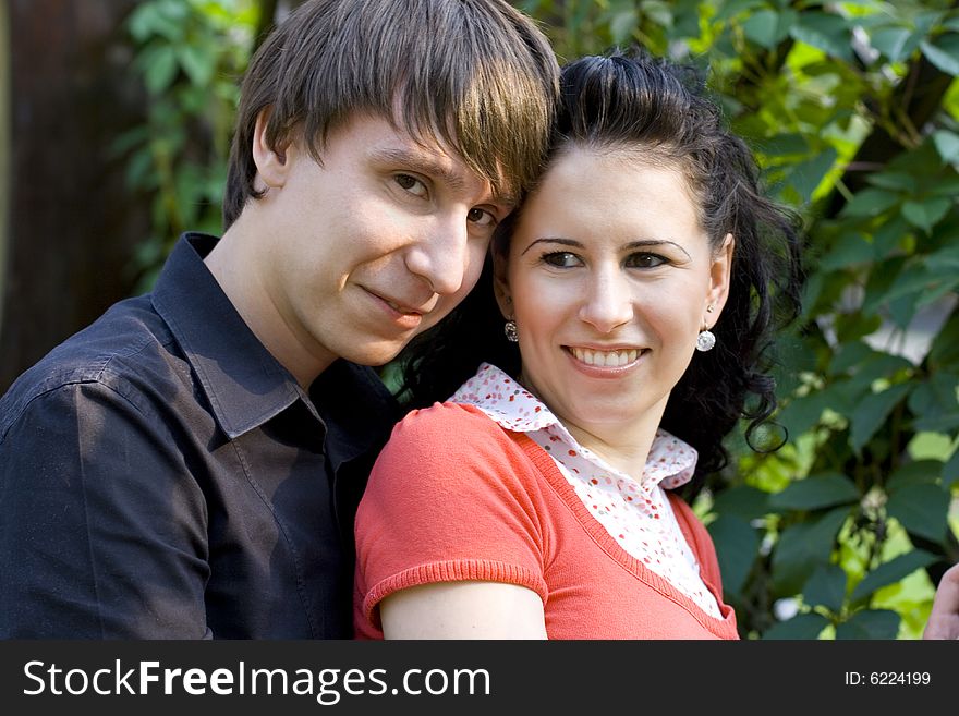 Outdoor portrait of young happy attractive couple together. Outdoor portrait of young happy attractive couple together