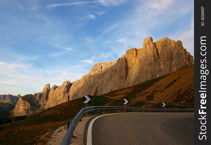 A wonderful shot of a street's bend in Sella pass with Dolomiti mountains in the background