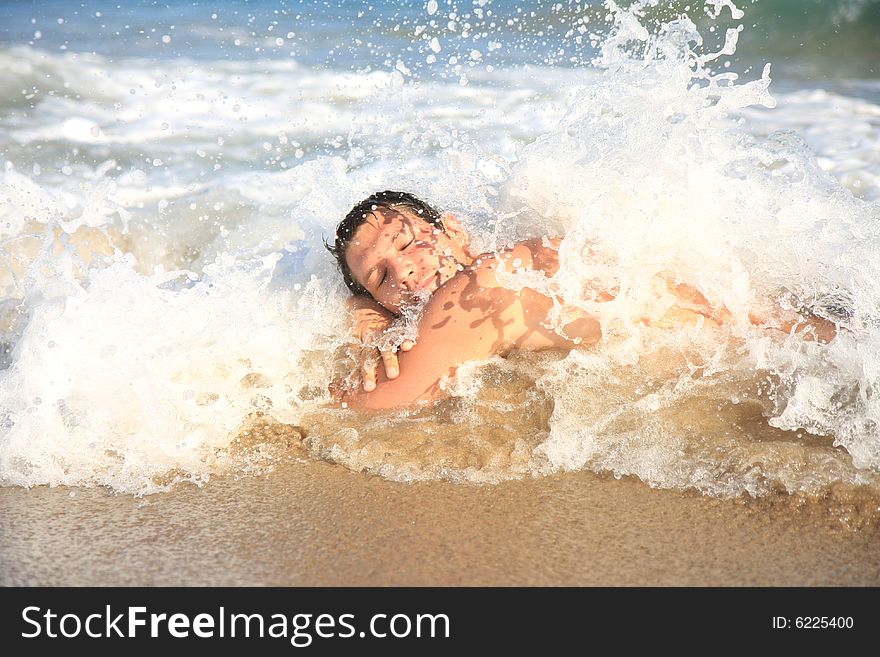 Man provocating waves and water drops on beach. Man provocating waves and water drops on beach