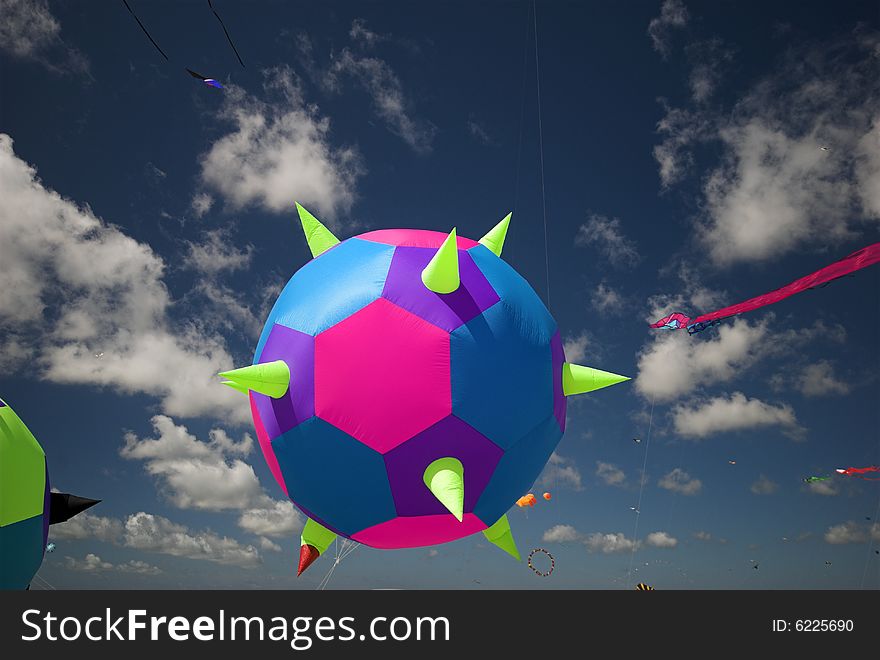 Round Fantasy Kite High-Up in the Blue Sky a Sunny Day on the Beach. Kite Flying Festival on Fanoe, Denmark. Round Fantasy Kite High-Up in the Blue Sky a Sunny Day on the Beach. Kite Flying Festival on Fanoe, Denmark.