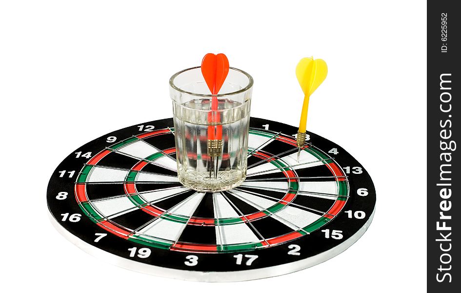 Glass of water and two darts on a dartboard (isolated on white). Glass of water and two darts on a dartboard (isolated on white)