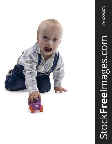 Merry boy playing with toy - car on white background. Merry boy playing with toy - car on white background