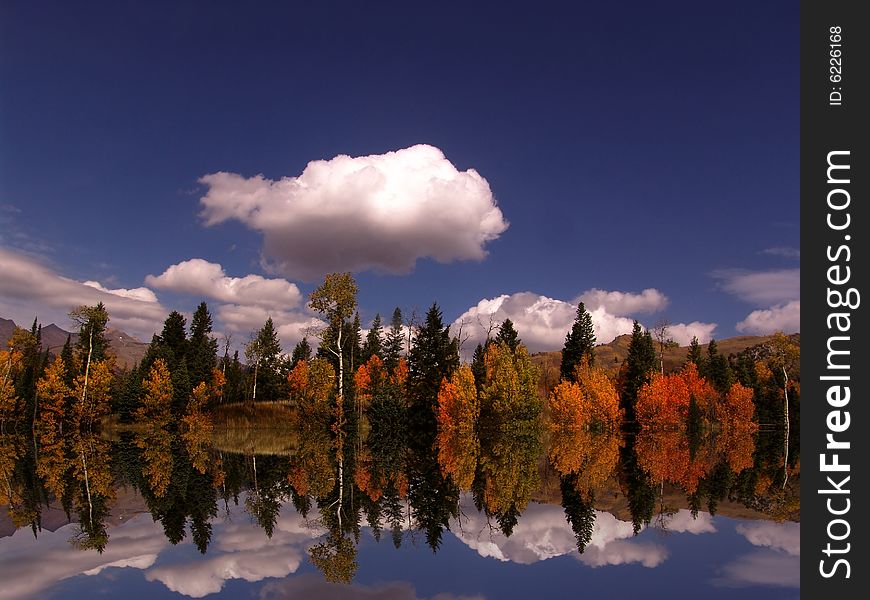 High mountain lake in the fall showing autumn colors reflected in the water
Americana. High mountain lake in the fall showing autumn colors reflected in the water
Americana